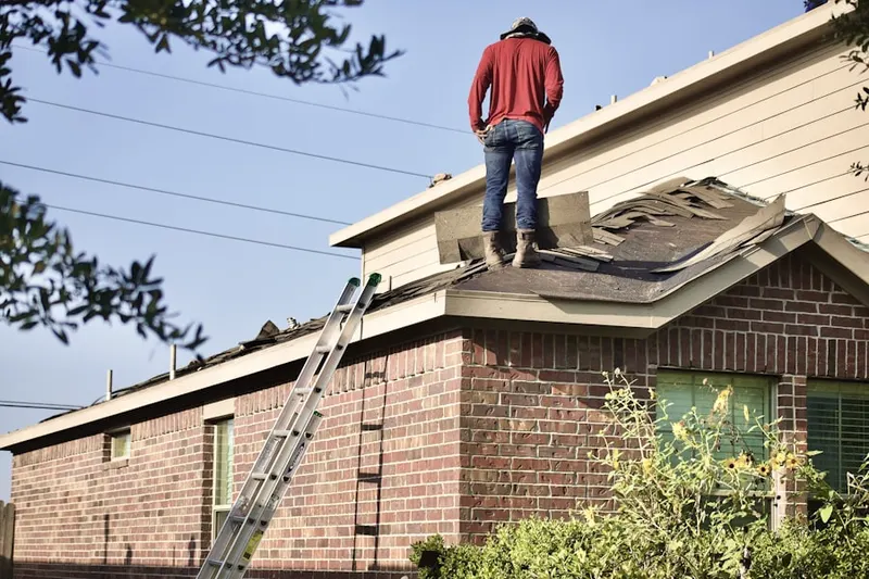 Professional roofer working on a residential roof in Travis Ranch
